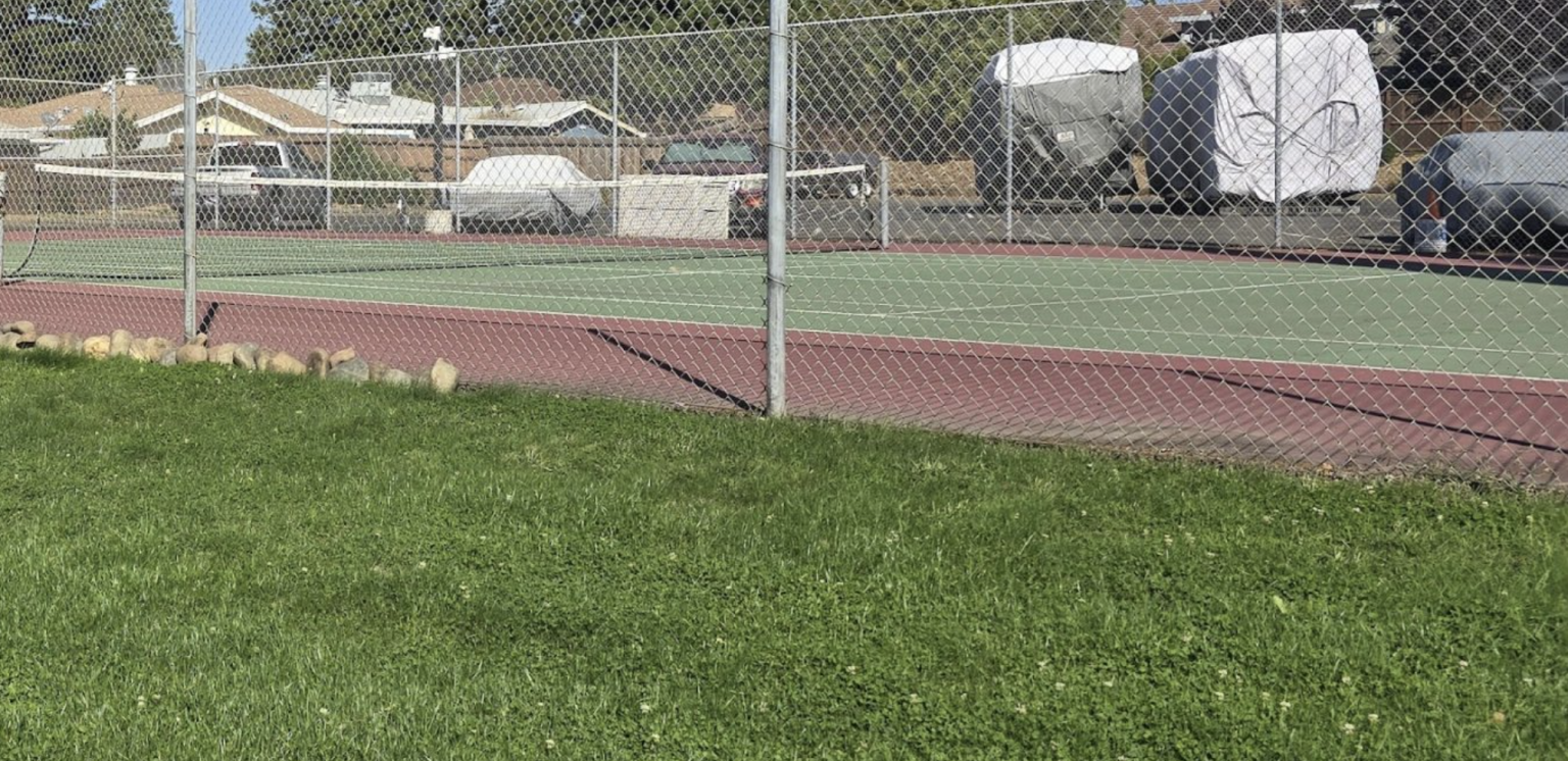 Partial completion of tennis court border rock placement